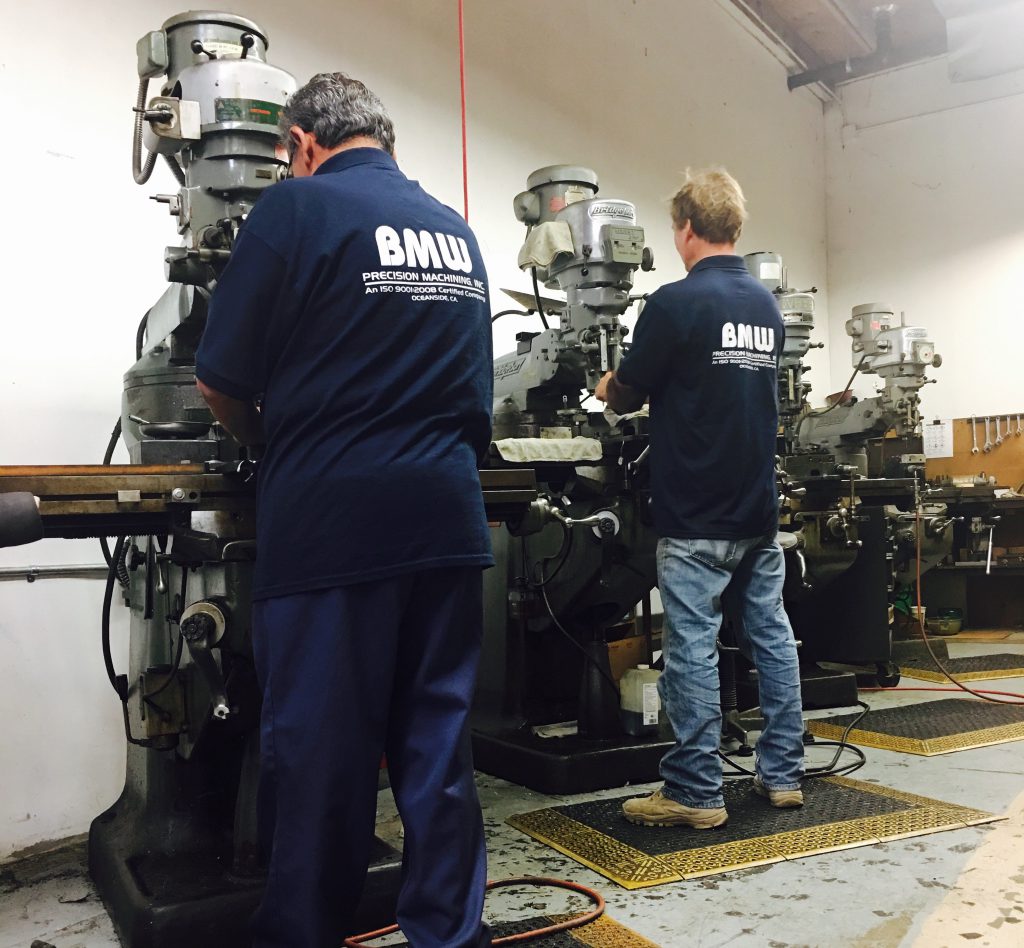 Machinists using milling machines