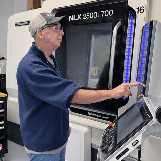 Operator programming a precision CNC Swiss machining and turning center at BMW Precision Machining.