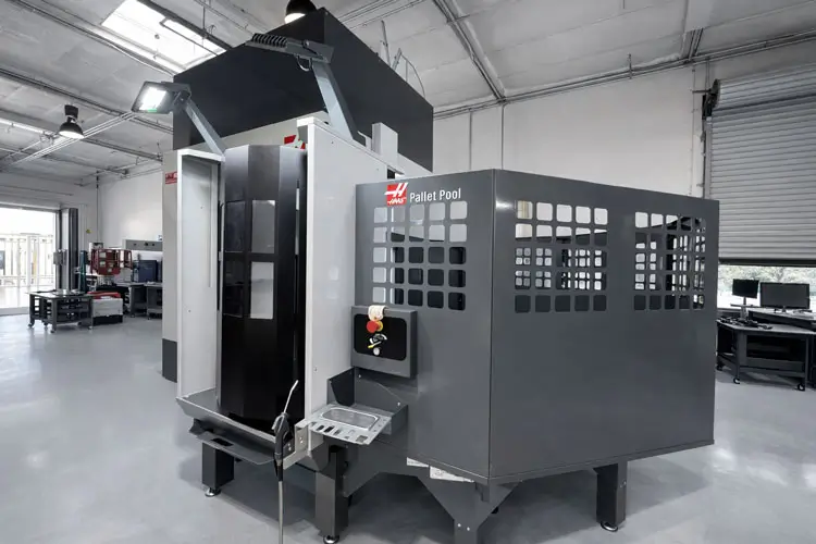 Automated Haas CNC milling center equipped with a multi-station pallet pool for lights-out production.